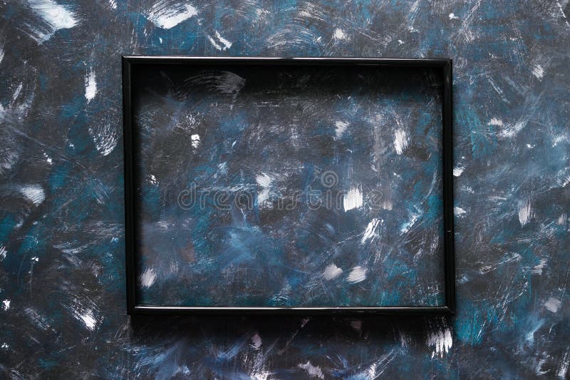 Black rectangular picture frame mock-up with copy space for yout text or image on top of hand painted navy blue background royalty free stock photography Black rectangular picture frame mock-up with copy space for yout text or image on top of hand painted navy blue background royalty free stock photography