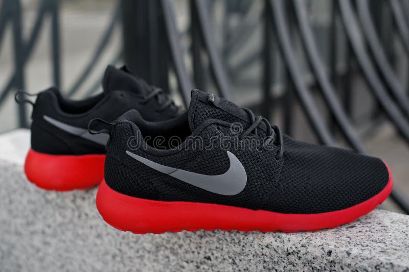 Black Red Nike Roshe Run Running Shoes, Sneakers on Grey Urban Background.  Krasnoyarsk, Russia - April 16, 2015 Editorial Photography - Image of shoe,  fashion: 173837982