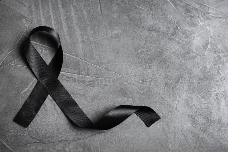 Black ribbon with space  text on grey stone background, top view. Funeral symbol