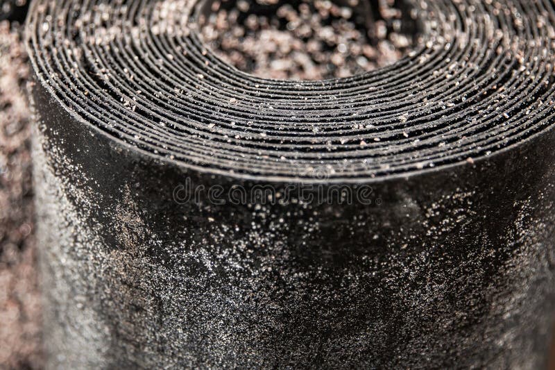 Black rolled waterproofing roofing material with detailed textured surface used in building insulation and renovation projects stock photography