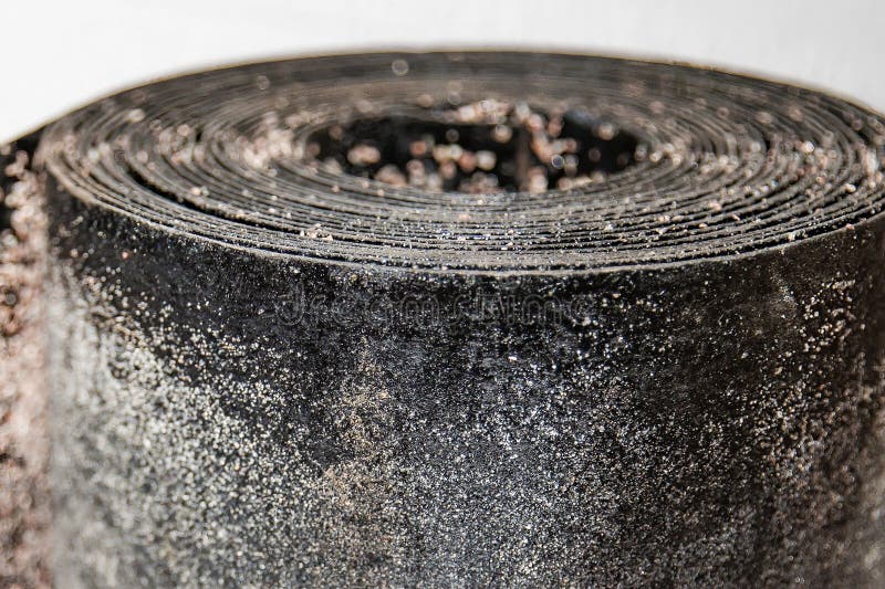 Black rolled waterproofing roofing material with detailed textured surface used in building insulation and renovation projects stock image