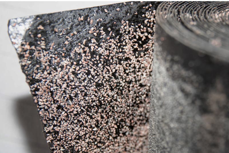 Black rolled waterproofing roofing material with detailed textured surface used in building insulation and renovation projects royalty free stock image