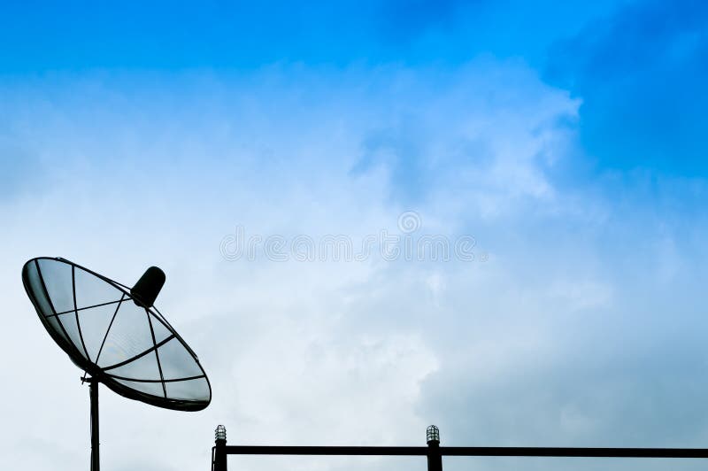 Black satellite dish or TV antennas on the building with the blue sky cloudy