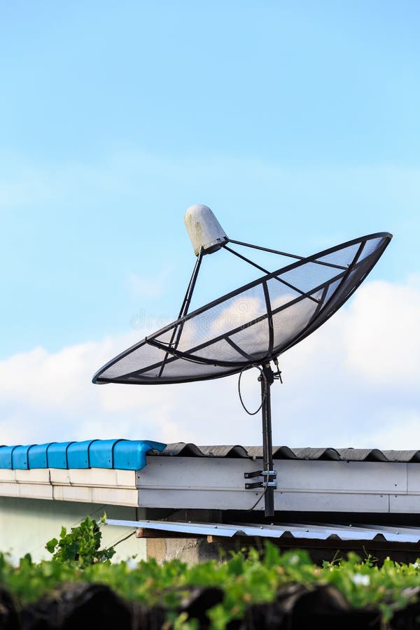 Black Satellite Install on the House Roof with Blue Sky Stock Photo