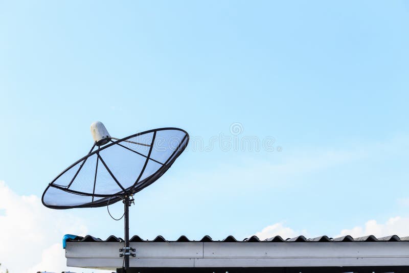 Black Satellite Install on the House Roof with Blue Sky Stock Photo