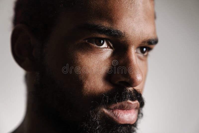 Black Shirtless Woman Smiling while Posing with Green Leaves Stock