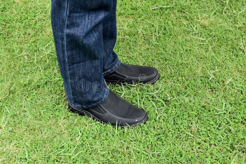 Black shoes on green grass stock photo. Image of fashion 57913314