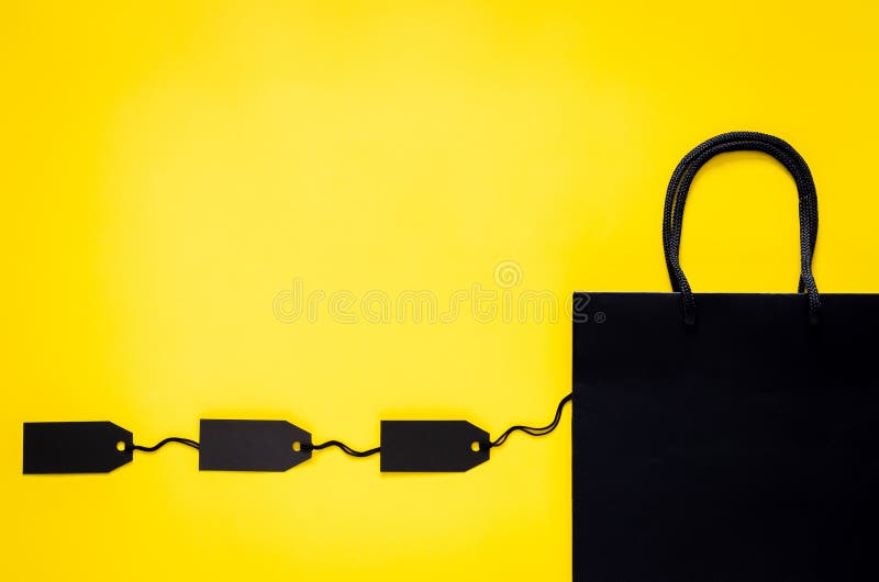 Black Shopping Paper Bag with Blank Black Price Tags on Yellow ...