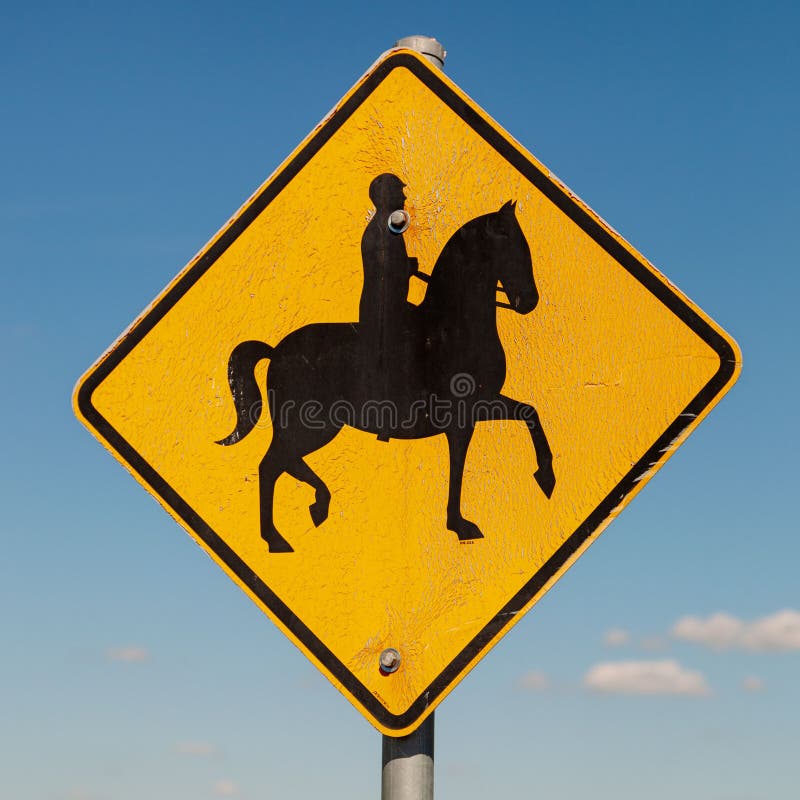 Black silhouette of male atop a horse - Australian signs found along the road. Black silhouette of male atop a horse - Australian signs found along the road