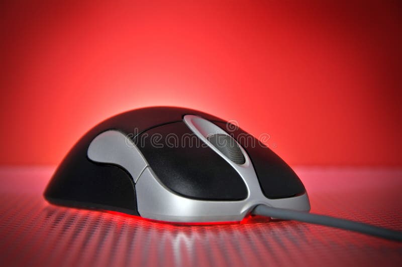 Black and Silver Wired Optical Computer Mouse on Red Background