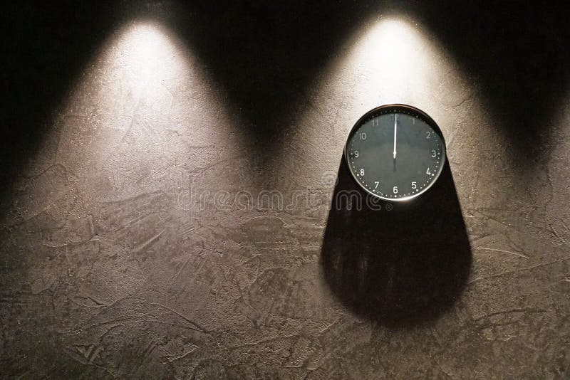 Black Simple Analog Clock Showing Midnight Hanging on the Wall with