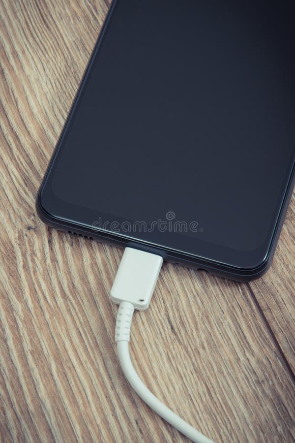 Black Smartphone and Connected Cable of Charger. Telephone Charging