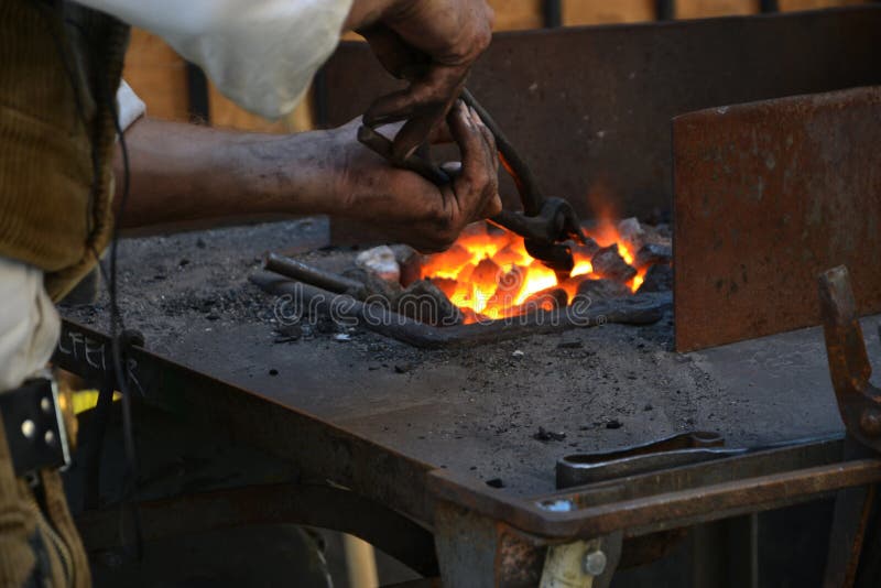 Black smith heating up an iron