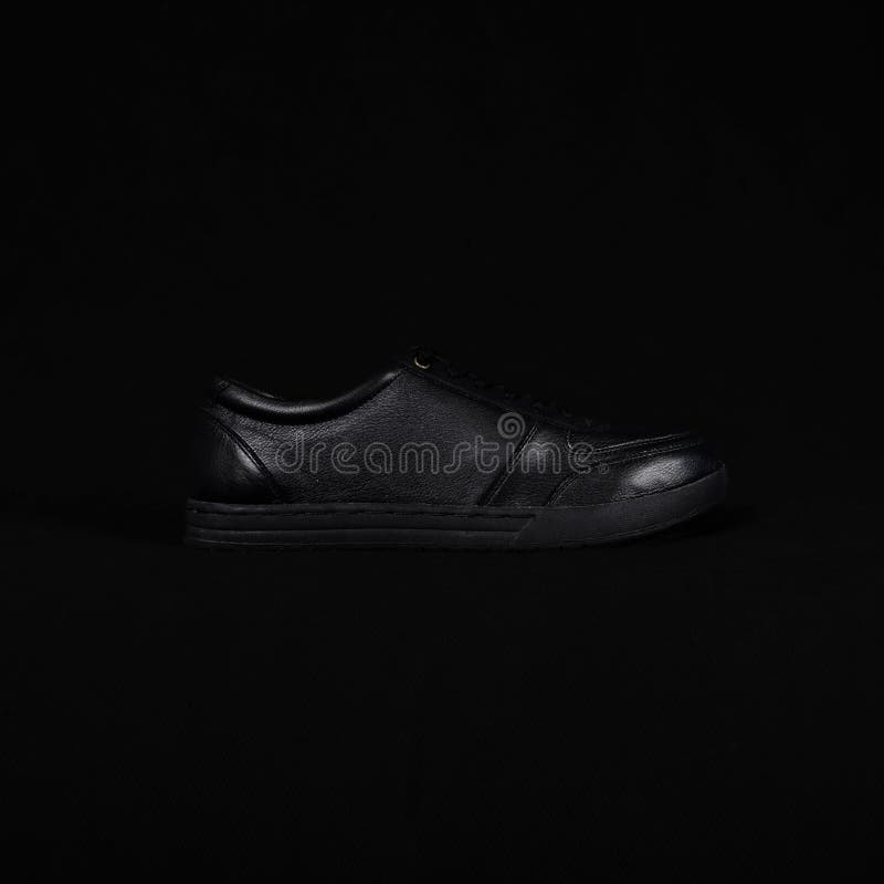 Free Photo  Elegant black leather shoes for men on black background photo  studio style ai generative