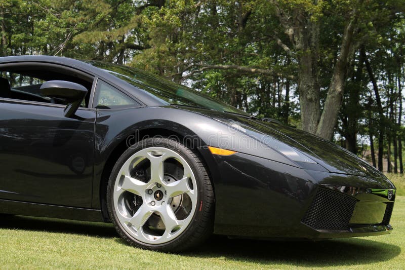 Black Lamborghini Gallardo coupe sports car. outdoors, sunny day. Black Lamborghini Gallardo coupe sports car. outdoors, sunny day.