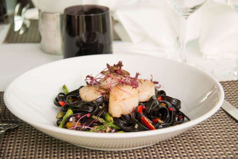 Black Squid Ink Pasta is Paired with Scallops Stock Photo Image of