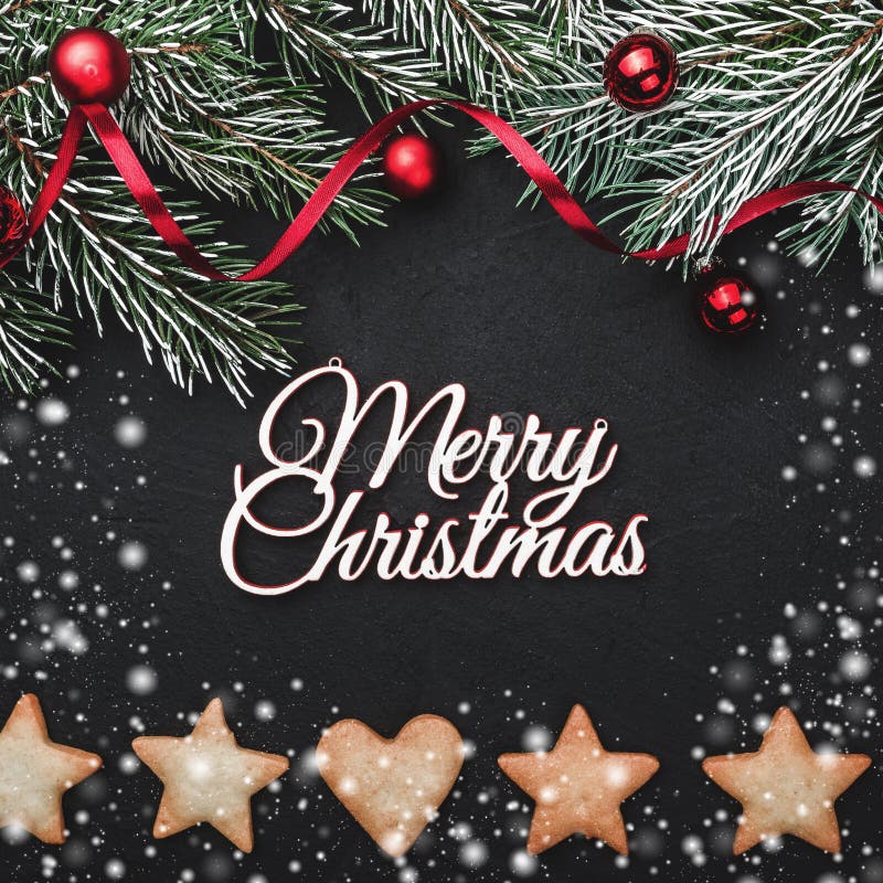 Black stone background, with fir branches adorned with red balls. Biscuits of various shapes. Top view royalty free stock images Black stone background, with fir branches adorned with red balls. Biscuits of various shapes. Top view royalty free stock images