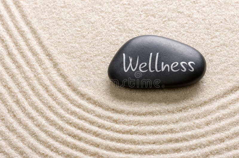 Black stone with the inscription Wellness