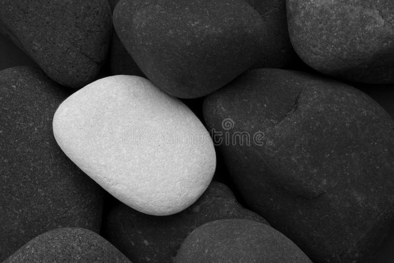 Black Stones And A Single White Stone Royalty Free Stock Photos Image