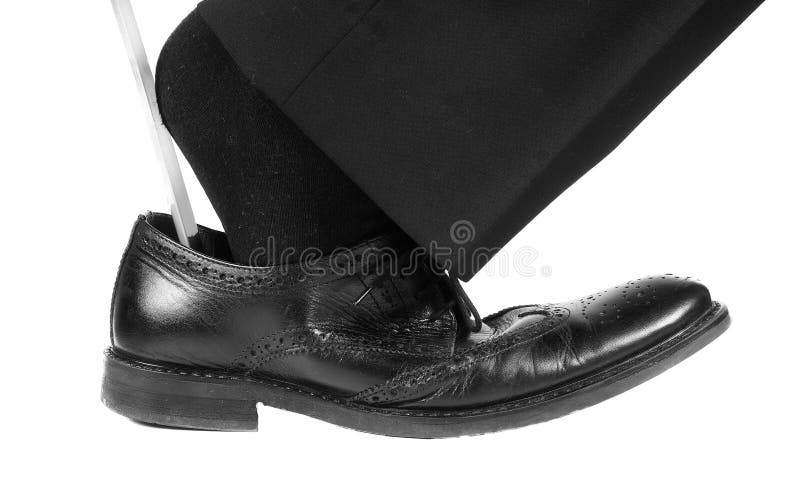 Black suit, socks into black leather shoe with shoehorn