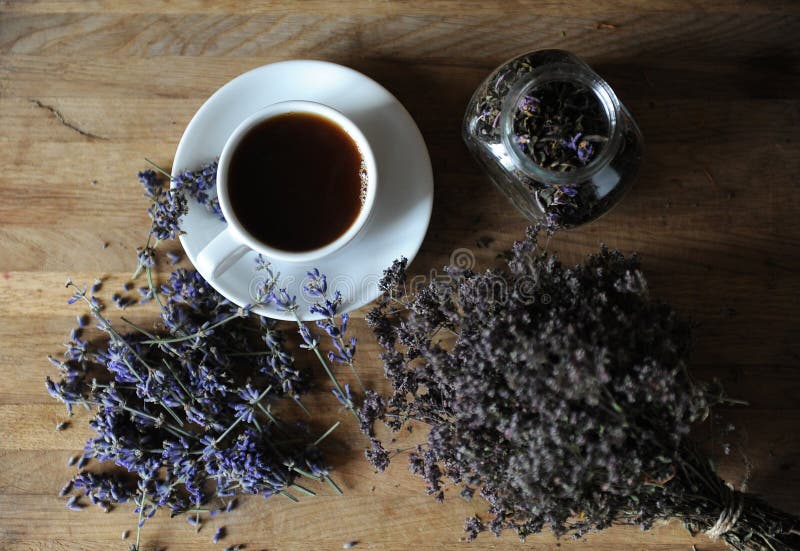 Black Tea or Coffee in a White Cup on a Board with Dried Herbs Stock