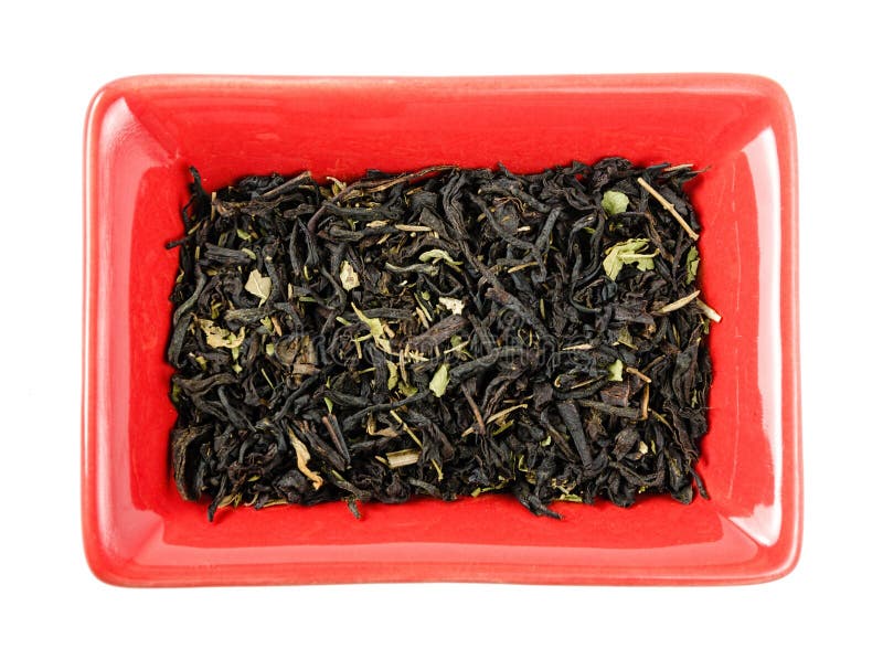 Black Tea Leaves in a Bowl. Isolated Stock Photo Image of green