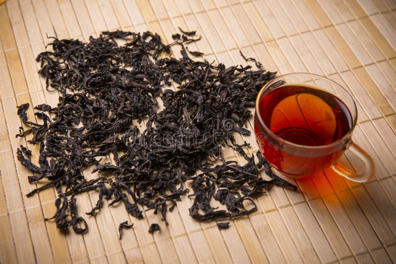 Black tea leaves and cup stock photo. Image of chinese 72928928