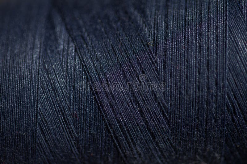 Black thread spool background stock image