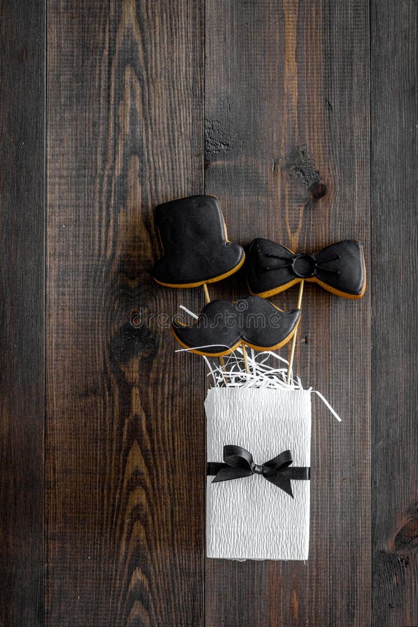 Black tie, mustache and hat cookies on sticks for happy father`s day present cookies wooden background top view space royalty free stock images Black tie, mustache and hat cookies on sticks for happy father`s day present cookies wooden background top view space royalty free stock images