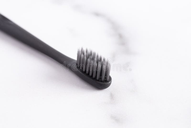 Black Toothbrush without Toothpaste on a Marble Counter Stock Image