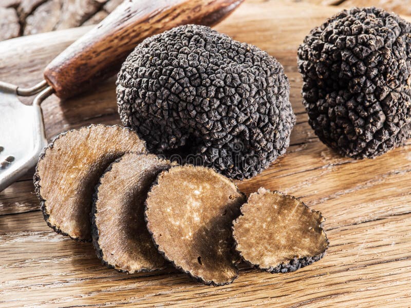 Black Truffles and Truffle Slices on a Graphite Board. Stock Image ...