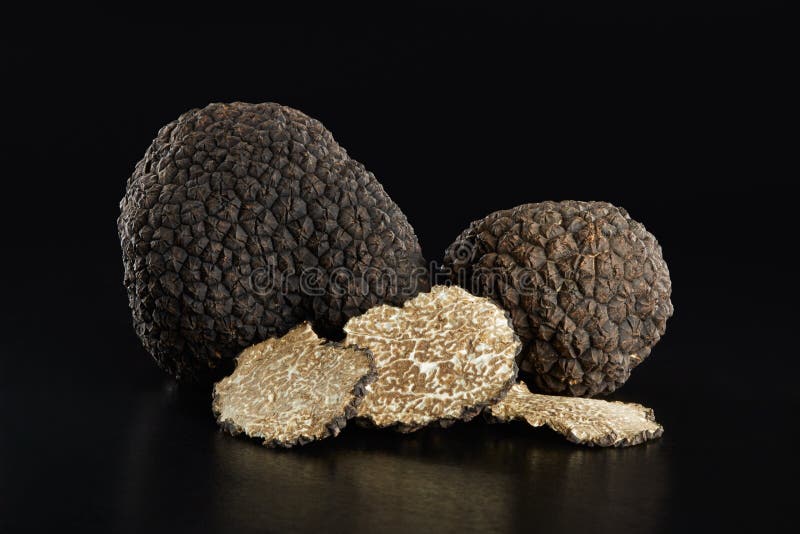 Black truffles and slices on black