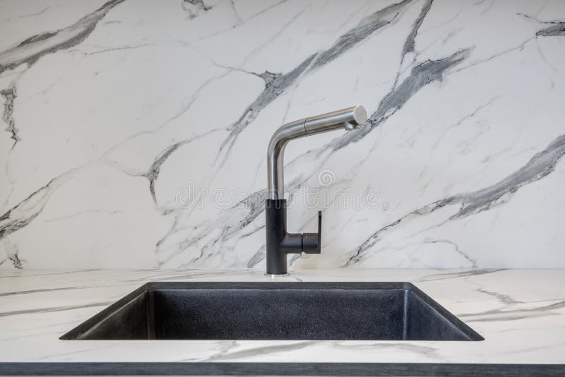Black Water Tap Sink with Faucet in Expensive Kitchen Stock Photo
