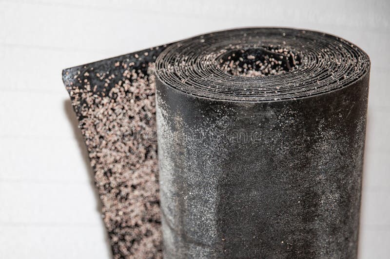 Black waterproofing roofing roll with rough textured surface prepared for building insulation and renovation work royalty free stock image