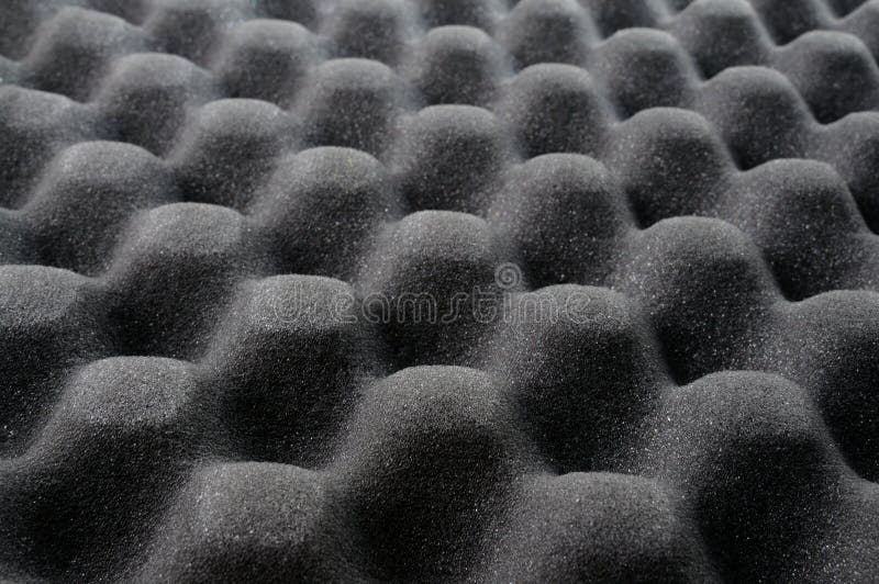 A heap of white shipping foam on black sheet of wavy foam rubber, Stock  image