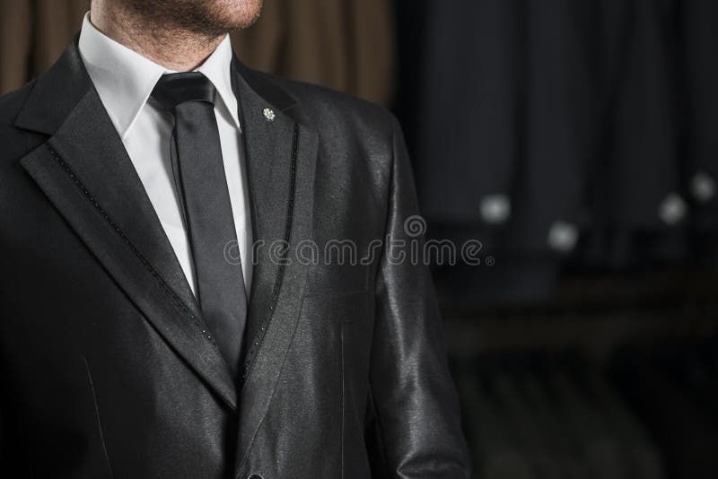 Young Male in a Black Wedding Suit and Tie over White Shirt