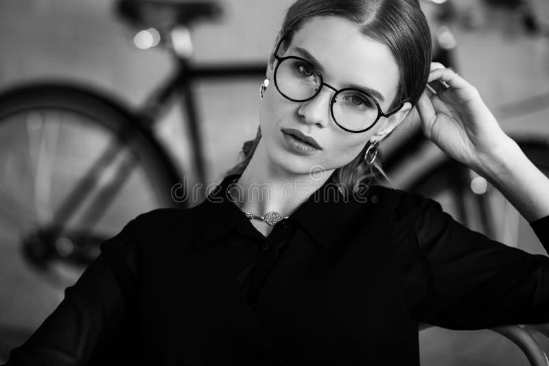 Black and white of attractive businesswoman in black clothes looking at camera and stock photography Black and white of attractive businesswoman in black clothes looking at camera and stock photography