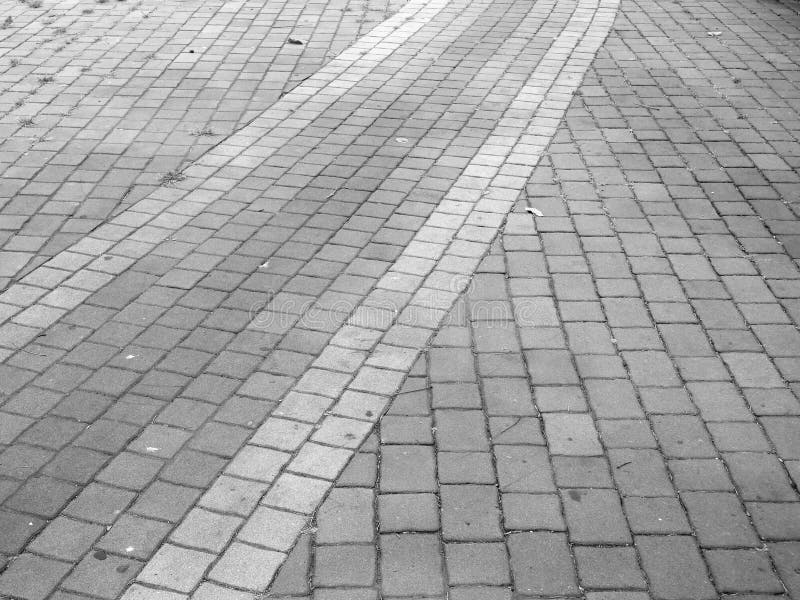 Black and white ,brick walk path in public park stock photo