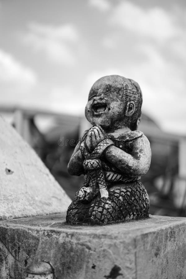 The black and white broken stone smile and happy kid statue.