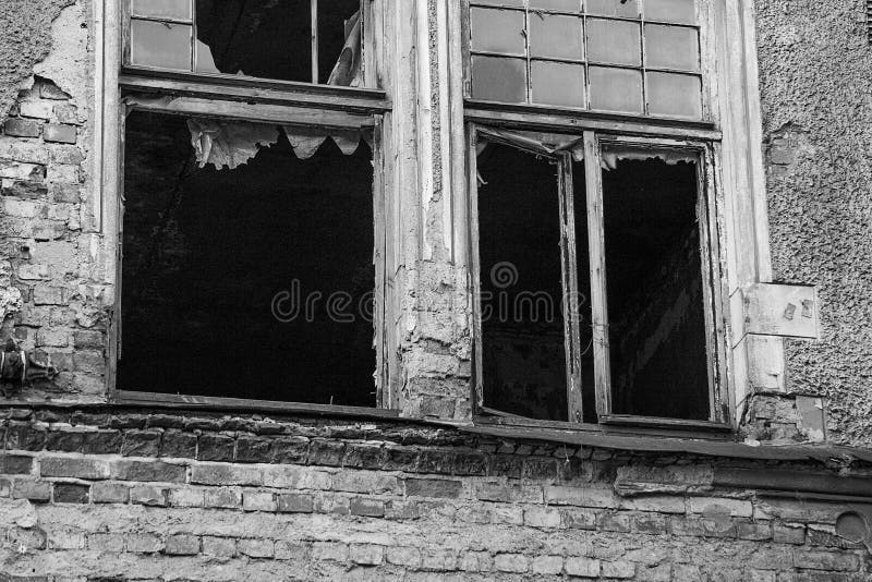 Monochrome broken windows of an abandoned burning building royalty free stock photo Monochrome broken windows of an abandoned burning building royalty free stock photo