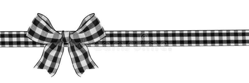 Black and white buffalo plaid Christmas gift bow and ribbon long border isolated on white