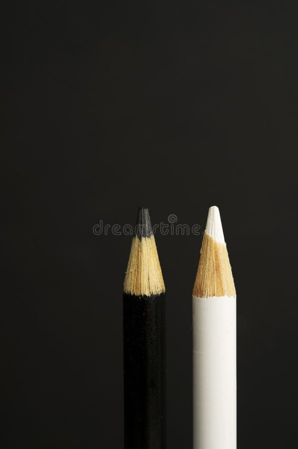 Black and White Coloured Pencil Crayons on a Black Background Stock