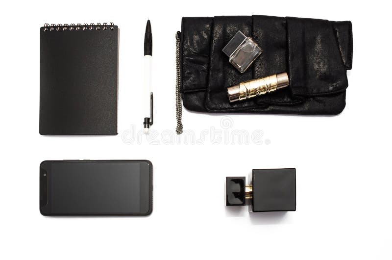 Black and white concept. Handbag clutch of a modern business lady with a mobile phone, credit cards, cash, notebook and pen. royalty free stock photo Black and white concept. Handbag clutch of a modern business lady with a mobile phone, credit cards, cash, notebook and pen. royalty free stock photo
