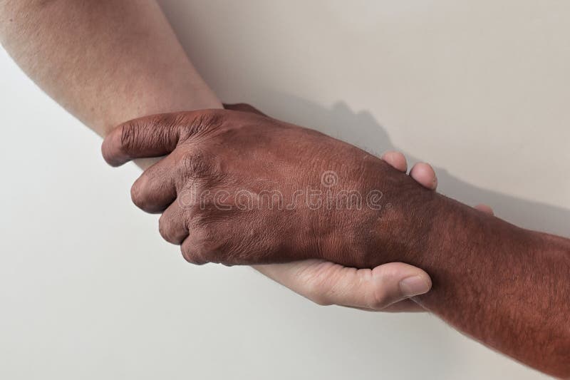 Conceptual Black And White Hands Holding Each Other
