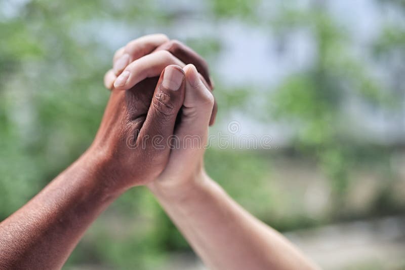 Black And White Hands Holding Each Other in Nature