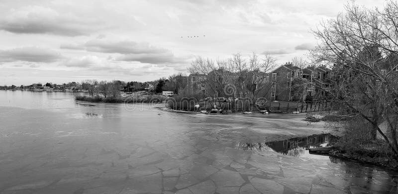 B&W Frozen Lake Lined With Houses and Apartment Buildings in Denver, Colorado stock photo