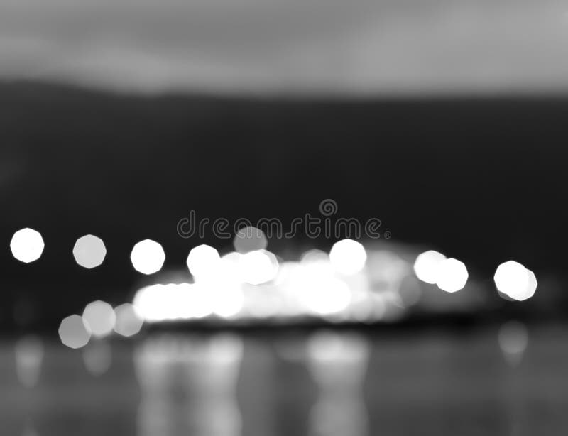 Black and white Norway night ship with lights bokeh background