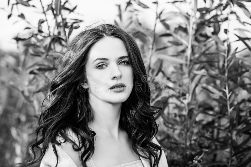 Black and white outdoors portrait of perfect young woman