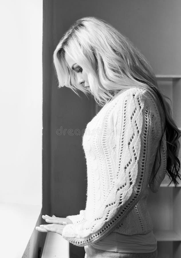 Black and white photo of lonely young woman stock photos