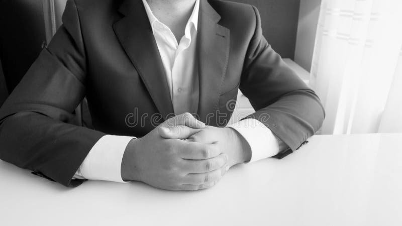 Black and white image of politician in suit sitting in office behind desk. Black and white photo of politician in suit sitting in office behind desk stock image Black and white image of politician in suit sitting in office behind desk. Black and white photo of politician in suit sitting in office behind desk stock image